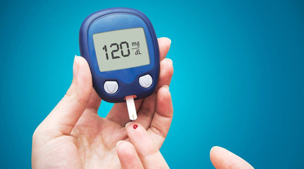 Person Using Glucometer to Measure Blood SUgar