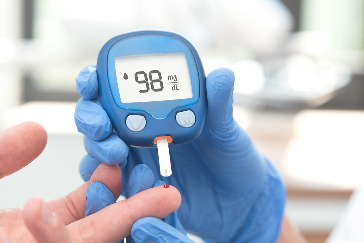 Doctor Making Blood Sugar Test in Clinic