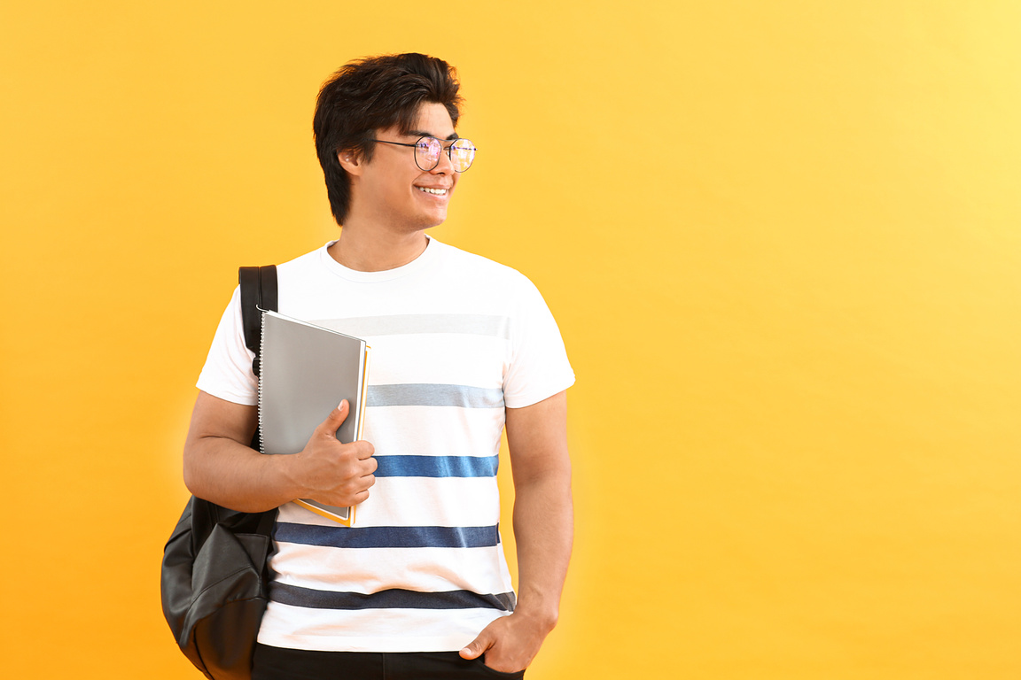 Portrait of Handsome Student on Yellow Background